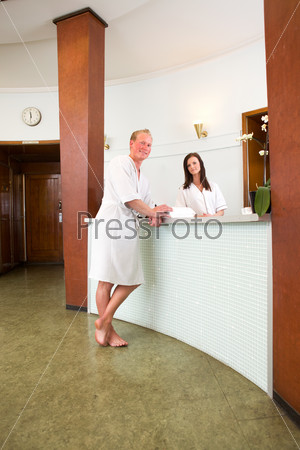 A customer in a spa reception in a bathrobe