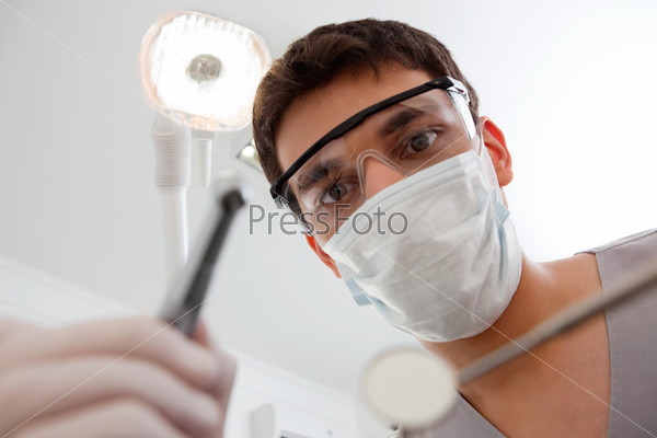 Dental technician with cleaning tools