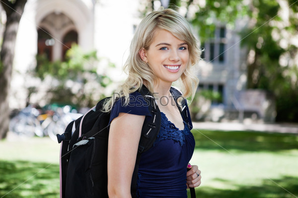 Portrait of sweet smiling college girl with backpack