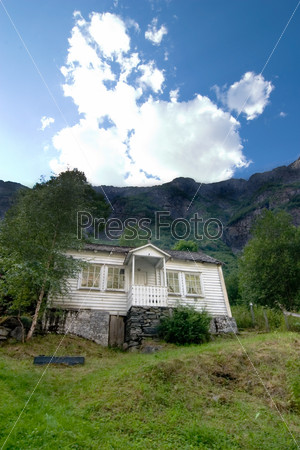 Mountains looming over a house in rural Norway