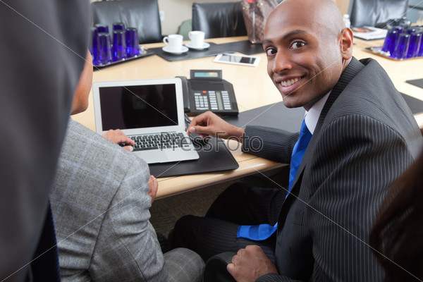 Portrait of an African American businessman working with colleague in office