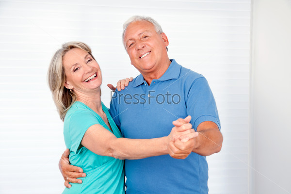 Portrait of elderly couple enjoying dance together