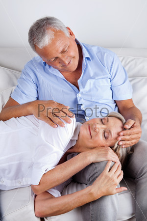 Relaxed woman asleep on husband\'s lap