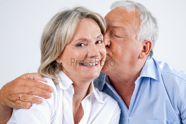 Woman Being Affectionately Kissed By Her Husband