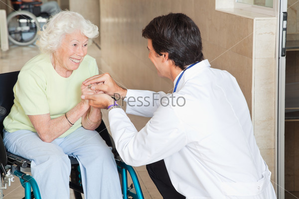 Doctor Comforting Happy Senior Woman