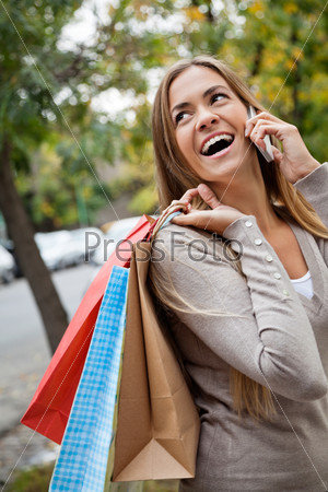 Woman On A Call While Carrying Shopping Bags