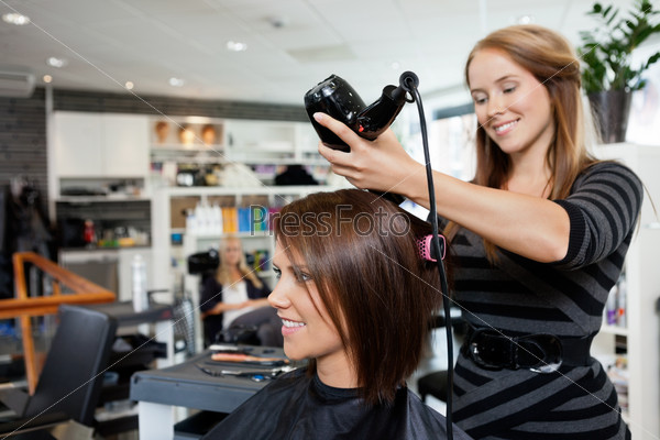 Beautician Blow Drying Woman\'S Hair After Giving A New Haircut At Parlor