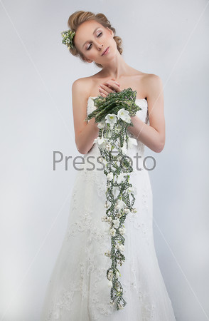 Floristics - attractive female bride blond hair model with floral bouquet of fresh tender flowers - series of photos