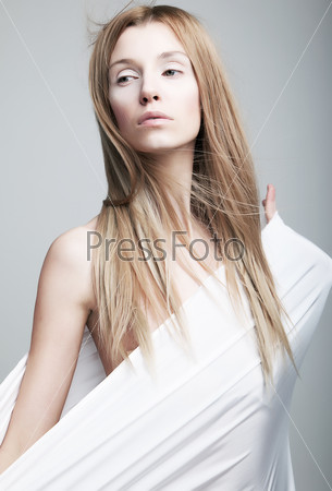 Lovely gentle half-dressed girl in white clothes like cocoon