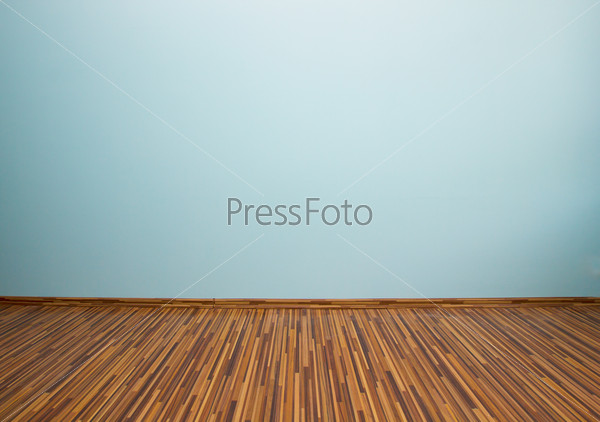 empty room with blue wall and wooden flor