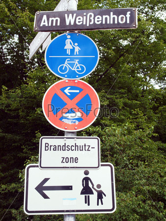 A road sign for a pedestrian zone, bike lane and no parking
