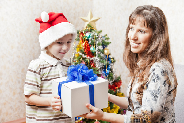 Mother and son with new year present or christmas holiday gift box, stock photo