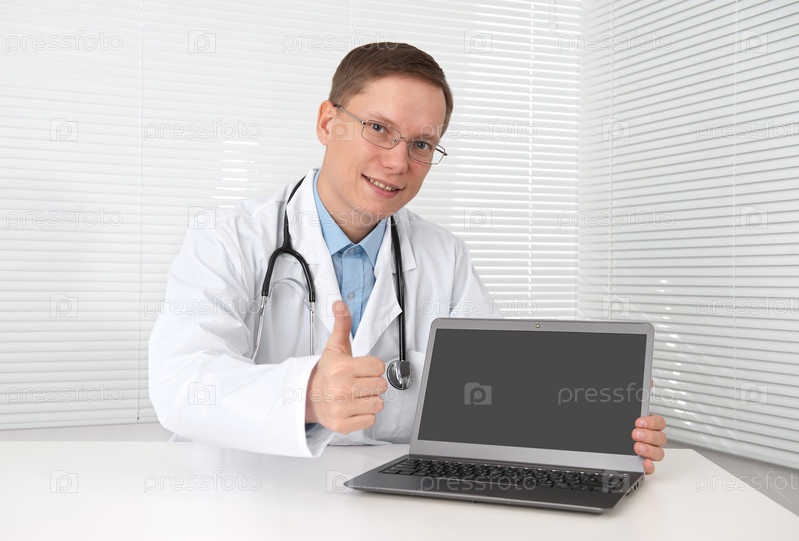 doctor with laptop computer showing thumbs up