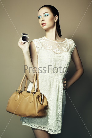 Portrait of beautiful young woman with bag