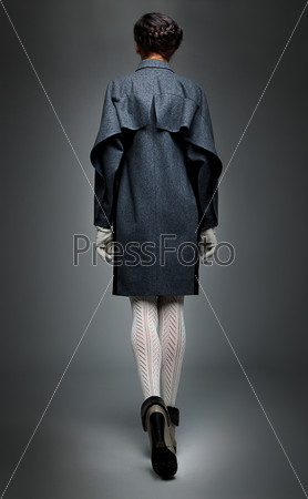 Aristocracy - slender brunette fashion model in  grey  coat  back elevation drawing. Series of photos
