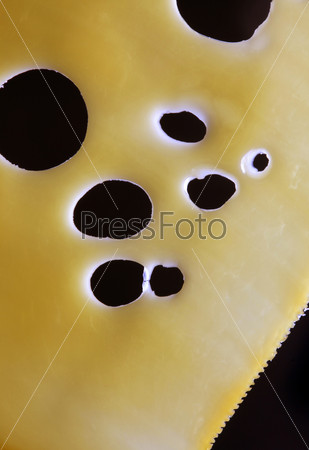 Thin slice of cheese on a black background