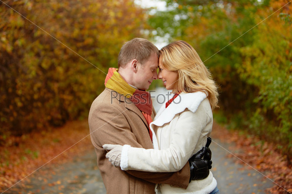Portrait of affectionate couple standing face to face in autumnal park