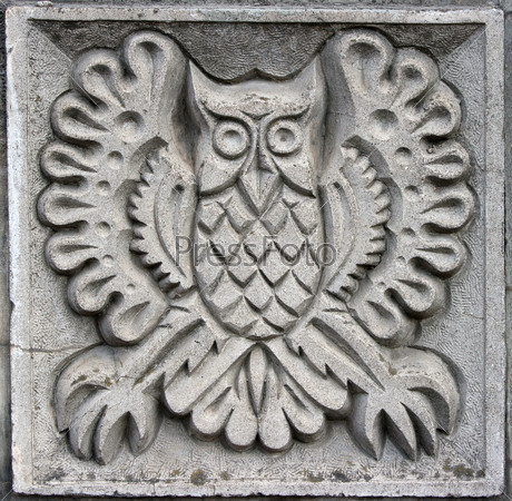 old bas-relief of fairytale fantasy owl on the wall
