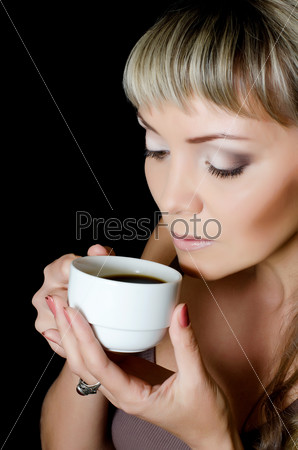 The beautiful elegant woman with a coffee cup