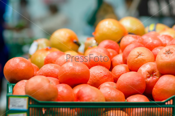 Red grapefruits in boxes in supermarket