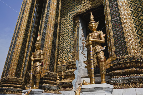 Thailand, Bangkok, Imperial Palace, Imperial city, golden statues at the entrance of a temple