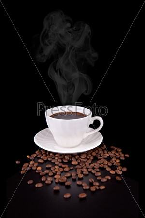 White cup with hot liquid and steam on black