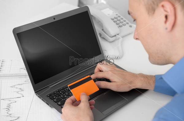 man shopping online with credit card and computer. Internet Shopping