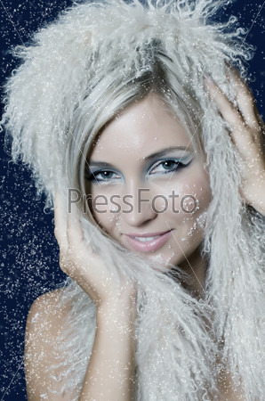 Winter Girl with beautiful make up, silver gloves and snow flake, blue background