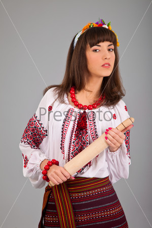 Attractive woman wears Ukrainian national dress isolated on a white background