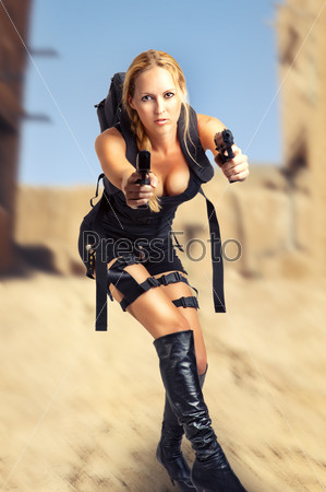 Sexy beautiful dangerous woman holding two hand gun