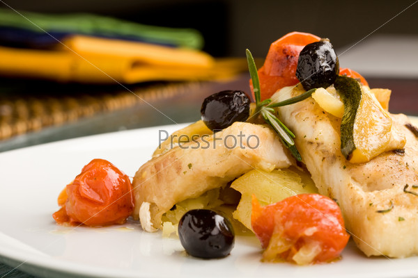 photo of delicious baked cod with olives and tomatoes