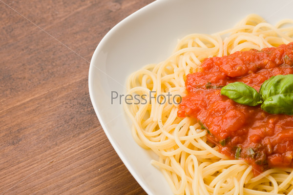photo of italian pasta with tomato sauce and basil