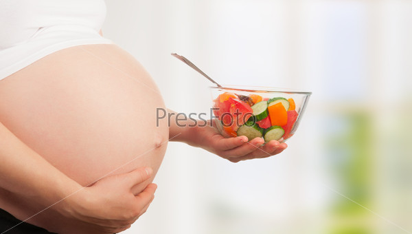 Healthy nutrition and pregnancy. pregnant woman and vegetable sa
