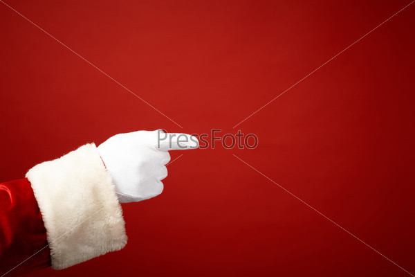 Photo of Santa Claus gloved hand in pointing gesture