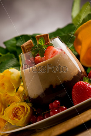 chocolate hazelnut mousse with berries in front of a rose background