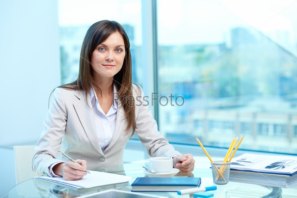 Portrait of young female writing proficiency test, stock photo