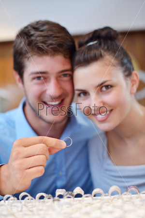 Happy young couple in jewelry store
