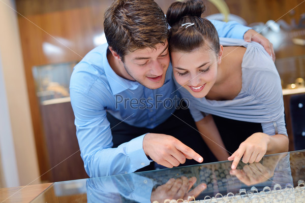 Happy young couple in jewelry store