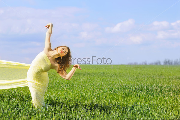 Charming flexible young woman wrapped in yellow cloth