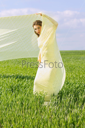 Cute young woman wrapped in yellow cloth