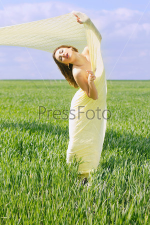 Charming young woman wrapped in yellow cloth