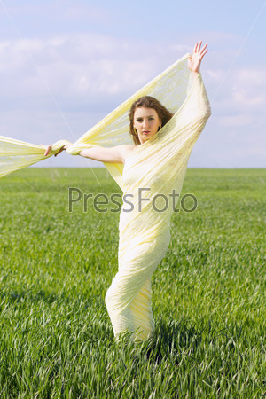 Expressive nice young woman wrapped in yellow cloth