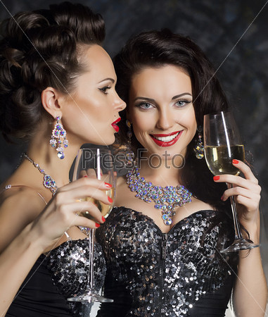 Christmas. Fashion women with wine glasses of champagne