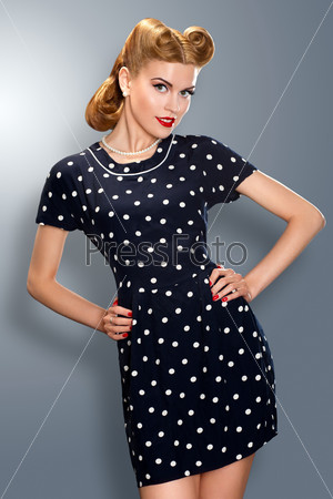 Heritage. Pin-up girl in retro vintage old-fashioned dress in romantic pose. Hipster
