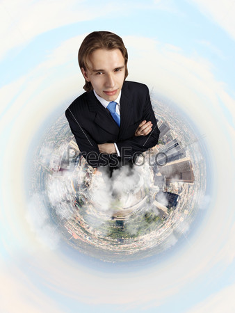 Planet earth against sky background and businessman standing on top of it