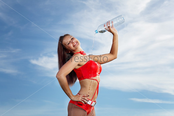 Young female sport girl with a bottle of water, stock photo
