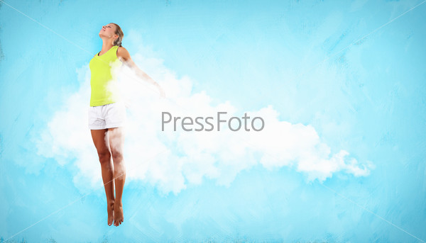 Portrait of a dancing young woman with white cloudy smoke around, stock photo