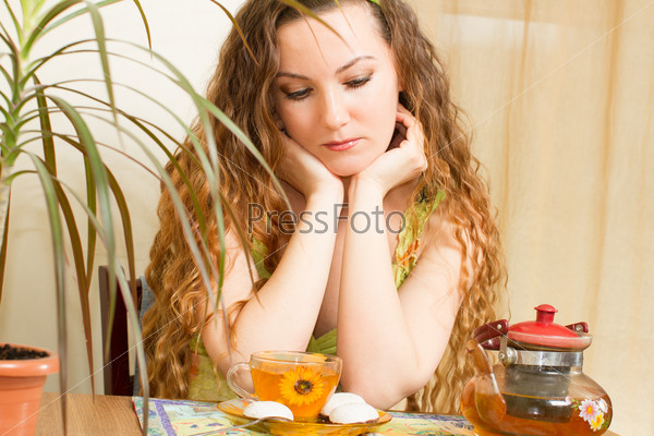 Portrait of young beautiful woman with tea  The concept of eating and drinking