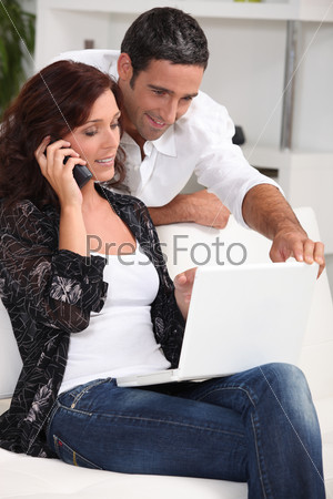 Couple with computer and phone