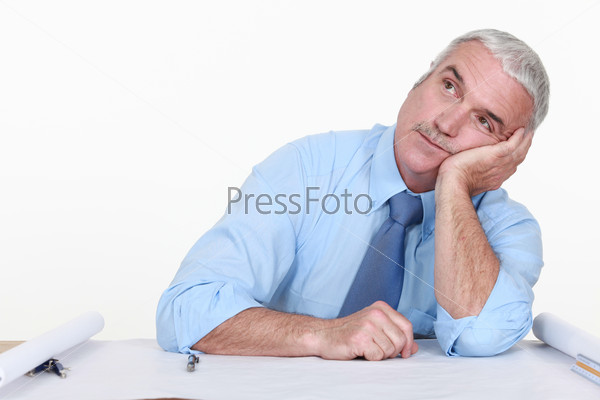 Bored architect staring off into space, stock photo